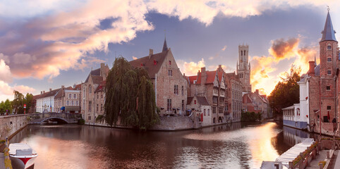Medieval fairytale town and tower Belfort from quay Rosary, at sunset, Bruges, Belgium