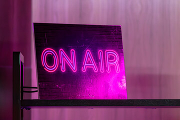 Neon sign with the inscription about live broadcasting. Work live. The work of a radio presenter....