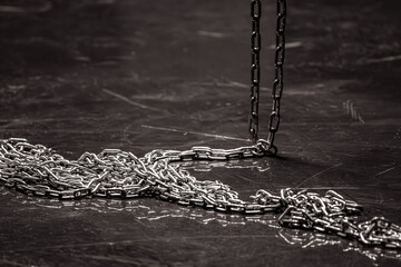 Iron chain on a dark background. Chain links. Solid rope. Steel structure. Sequential connection of...