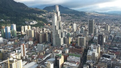 Aerial view to the north, urban landscape full of tall buildings surrounded by mountains in Bogotá, Colombia.