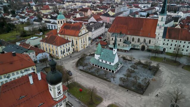 Aerial Flight towards Gnadenkapelle in Altoetting next to town hall at christian pilgrim spot
