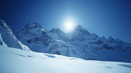 Fototapeta premium On a clear day the sun shines down on the snowcovered mountains creating dazzling glistening peaks.