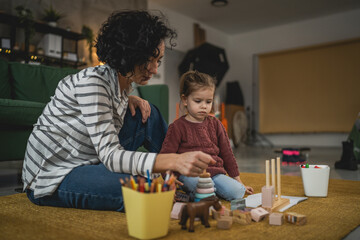 Mother and daughter toddler child play at home