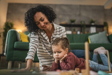 Fototapeta premium Mother and daughter toddler child play at home