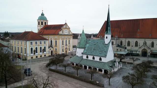 Straight flight towards Gnadenkapelle with St Magdalena church in background in Altoetting