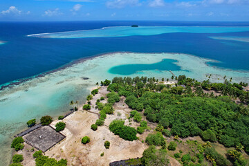 Aerial view of the coral reef, South Pacific Ocean, and the island of Raiatea near the Marae Taputapuatea in Opoa on the south eastern coast of Raiatea