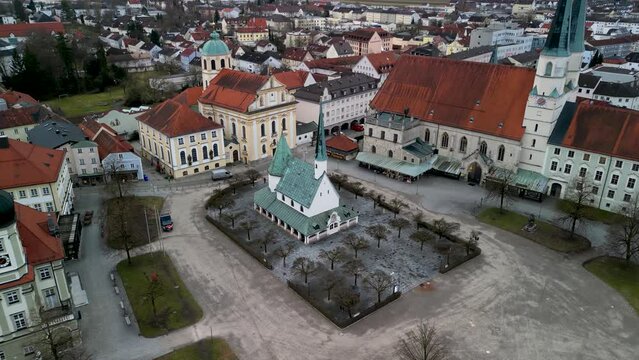 Aerial overview in sideways flight of Kapellplatz with churches in Altoetting