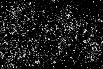 Macro sea ​​salt grains, crystals scattered isolated on black, texture
