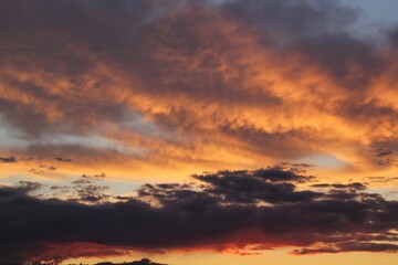 Twilight sunset sky. Nature background. Soft golden clouds. Sunrise early morning. Dramatic pastel panorama. Aerial view. Abstract landscape texture