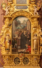  LUZERN, SWITZERLAND - JUNY 24, 2022: The carved polychrome side altar with painting of St. Nicholas in the church St. Leodegar im Hof by Niklaus Geisler (1585-1665) © Renáta Sedmáková