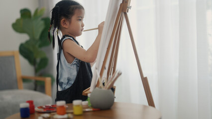 little girl drawing in the living room