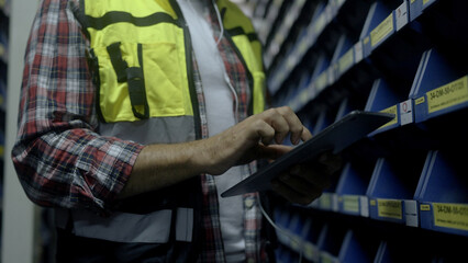 Employee is checking the goods in the warehouse.