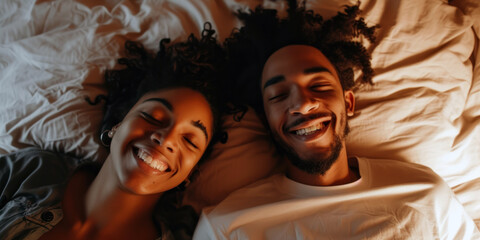Two people are lying down and smiling. A relaxed and happy couple experiencing a moment of joy and pleasure