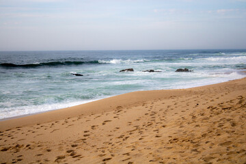waves on the beach with sand