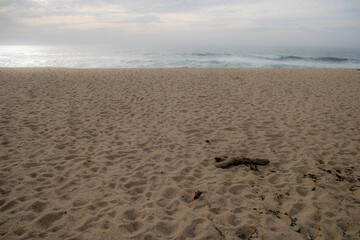 footprints on the beach, waves on a sand