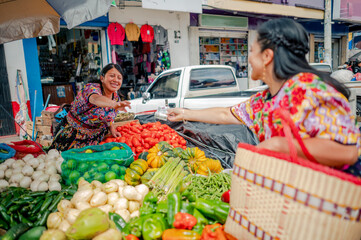 Cash exchange between a Latin buyer and a Latin seller in a Mesoamerican market.