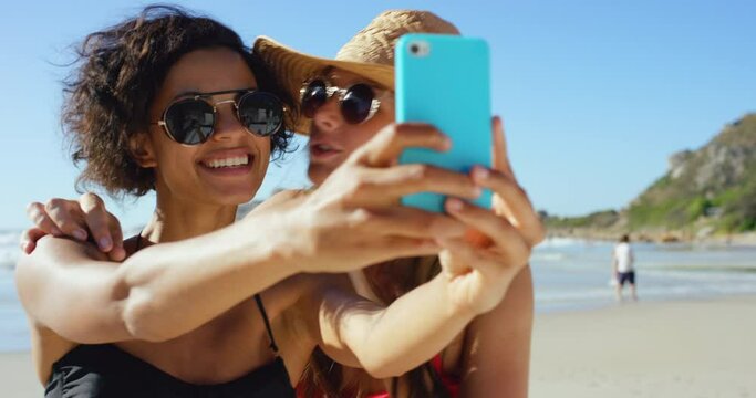 Women, friends and selfie on beach with kiss for holiday connection, social media or bikini. Female people, travel and happiness in Bali together for summer bonding or internet post, weekend or trip
