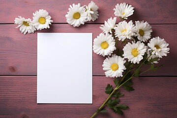Obraz premium mockup white blank paper sheet with white daisies flowers top view on painted wooden background, floral template empty card flat lay for design with copy space