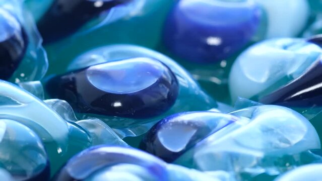 A close up of a bunch of laundry detergent pods in a container