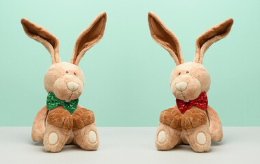 Two plush hares with a bow tie around their neck