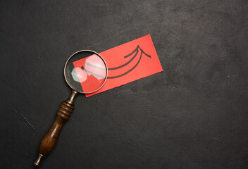 Magnifying glass and paper sheet with arrow, symbolizing the concept of searching for solutions