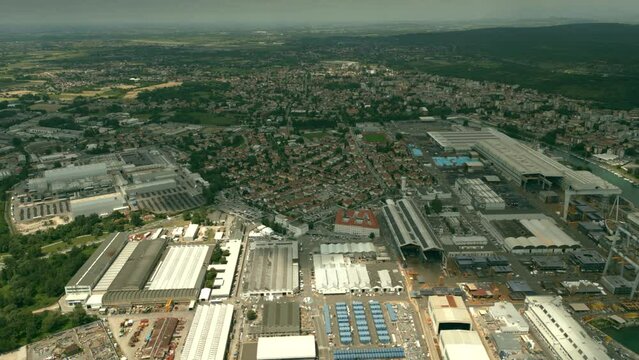 Aerial shot of industrial facilities, warehouses and residential area in Monfalcone, Italy