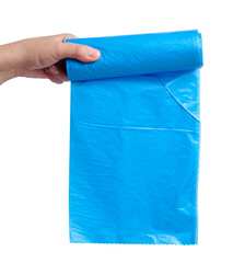 A woman's hand holds a roll of plastic bags for the trash can