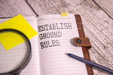 Establish Ground Rules, text words typography written on paper against wooden background, life and...