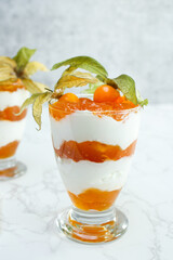 Layered dessert with protein yoghurt and physalis fruit
