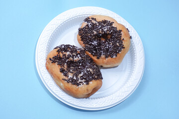 donut cake sprinkled with chocolate sprinkles in a white container
