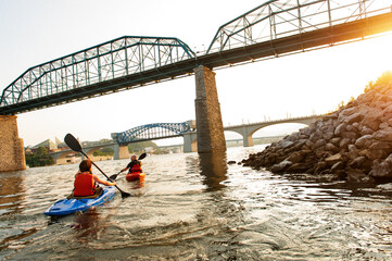 Two kayakers paddle the Tennessee River beneath the Walnut Street Bridge in Chattanooga. 