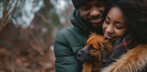 portrait of a couple hugging their new pet dog, with copy space