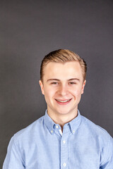 portrait of smiling teenage boy isolated on black