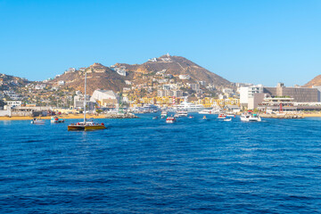 Boats cruise the harbor on a busy day at the bay, marina, port town of the Mexican resort town of...