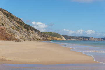 Praia das Furnas beach on a sunny day with clear blue sky, Algarve, Portugal.