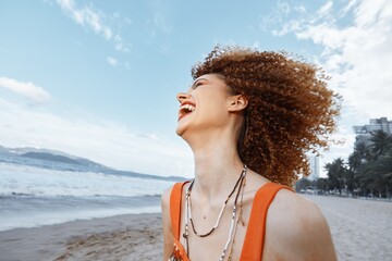 Happy Smiling Woman with Curly Hair Enjoying Freedom on Beach Vacation