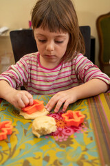 Little girl preparing cookies to be baked