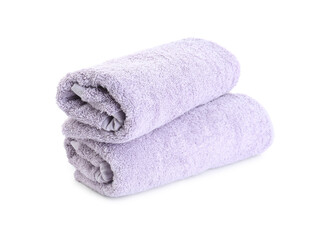 Rolled violet terry towels isolated on white