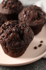 Delicious fresh chocolate muffins on table, closeup