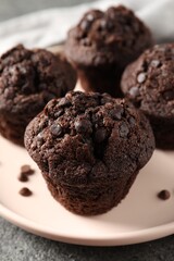 Delicious fresh chocolate muffins on table, closeup
