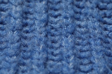 Texture of soft blue knitted fabric as background, closeup