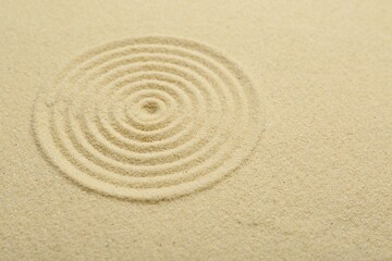 Zen rock garden. Circle pattern on beige sand