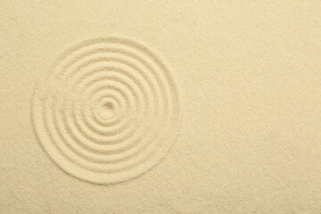 Fototapeta na wymiar Zen rock garden. Circle pattern on beige sand, top view