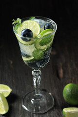 Alcohol Cocktail with Lime, Blueberry, Ice, and Mint