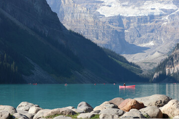 Canoe in the clear water mountain lake 