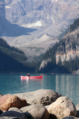 Canoe in the clear water mountain lake 
