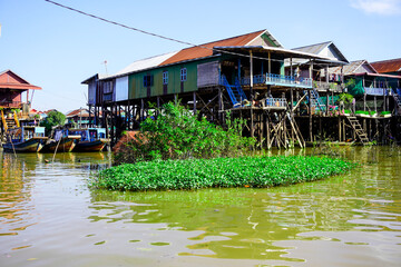 Fototapeta na wymiar Siem Reap, Cambodia -December 11, 2023 : boat trip on the River in Cambodia. Fishing villages and houses on the water