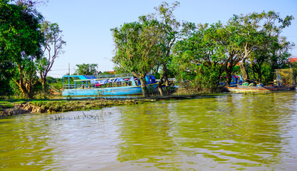 Siem Reap, Cambodia -December 11, 2023 : boat trip on the  River in Cambodia. Fishing villages and...