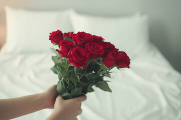 Red rose and personalized hand with Valentine's Day gift Surprise bouquet and flower arrangement on the bed in the house for the anniversary