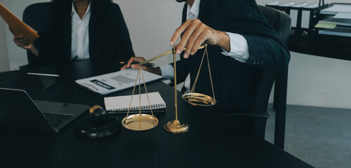 Judge gavel with Justice lawyers having team meeting at law firm background. Concepts of Law and...